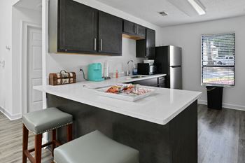 the preserve at ballantyne commons apartment kitchen with island and stools